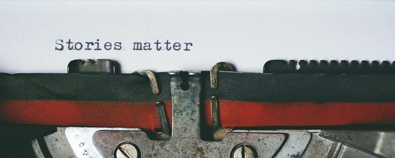 Close-up of a vintage typewriter with the text 'Stories matter' typed on paper, evoking nostalgia.