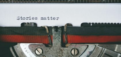 Close-up of a vintage typewriter with the text 'Stories matter' typed on paper, evoking nostalgia.