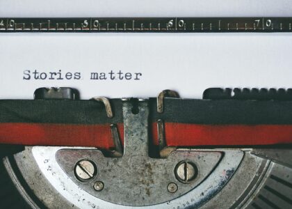 Close-up of a vintage typewriter with the text 'Stories matter' typed on paper, evoking nostalgia.